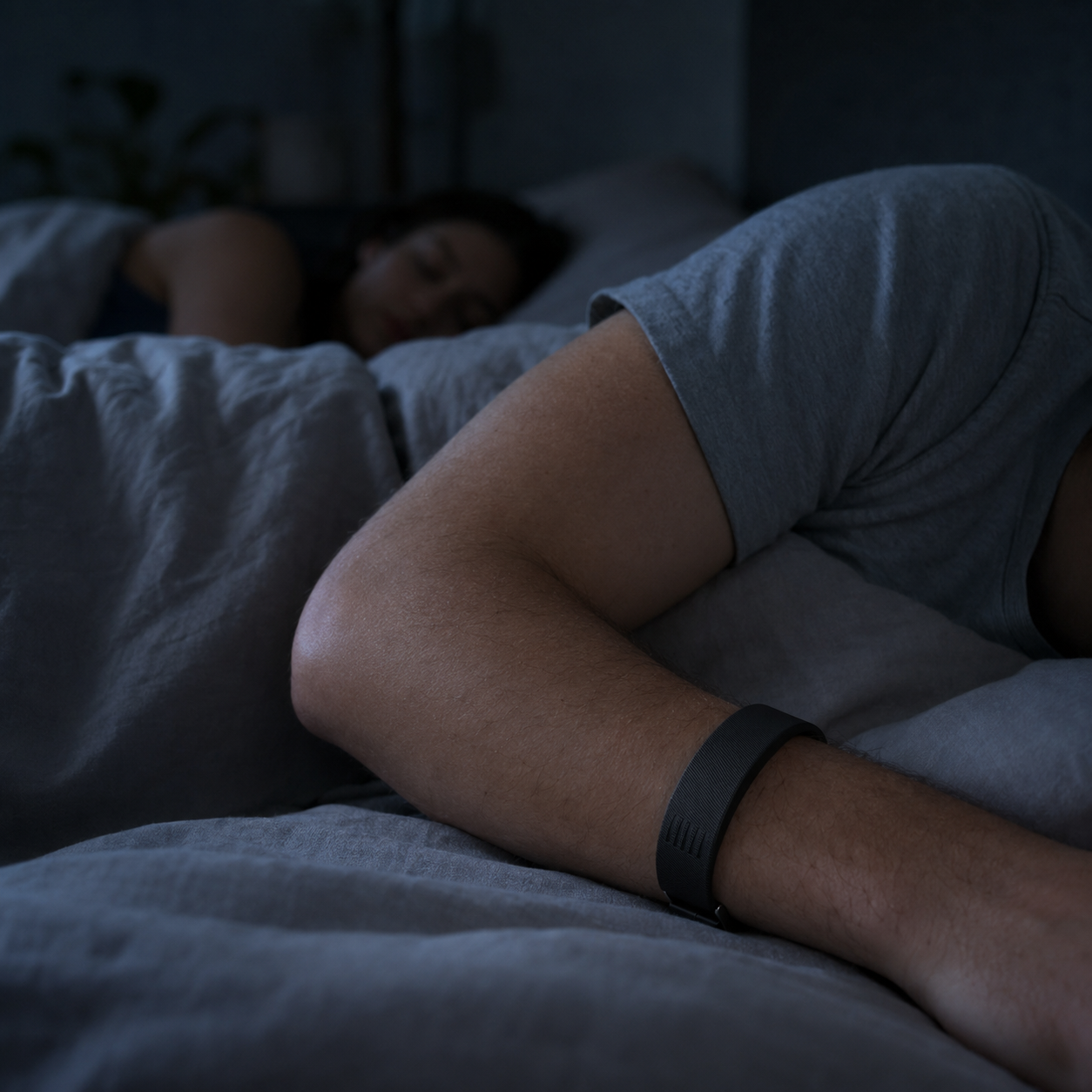 Spark alarm wristband worn while a partner sleeps undisturbed